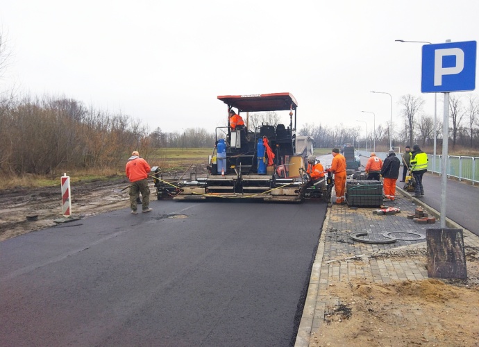 Układanie drugiej warstwy asfaltu na skrócie łączącym ulicę Wyszkowską z ulicami Sukienniczą i Zaułek 7